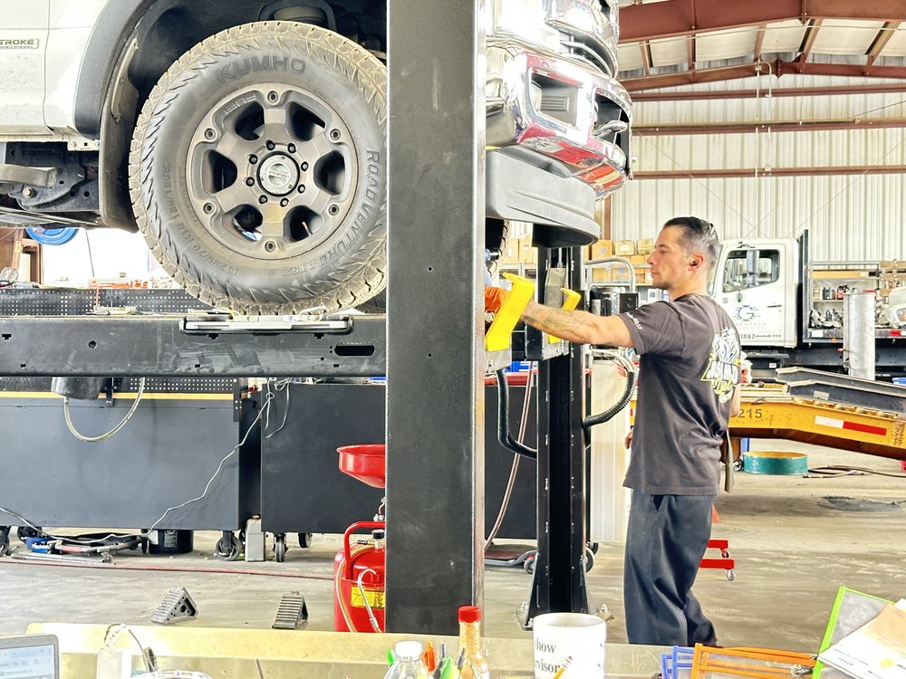 A technician working under a truck on the lift at Bonafide Truck and Equipment Repair, Cherry Valley, CA